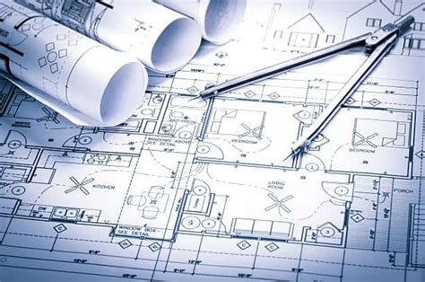 Compass and rolled blueprints on architectural plan